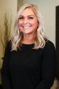 A woman with blonde hair wearing black shirt.